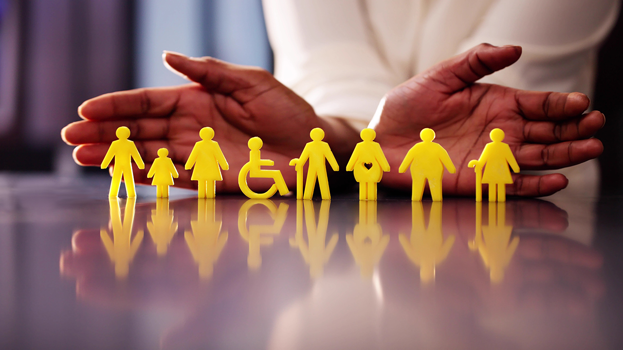 Hands protecting persons with disabilities